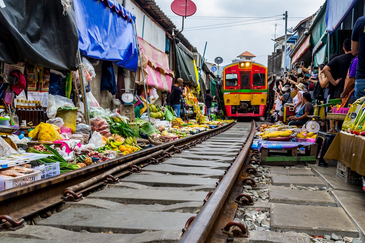 Train passing through Maeklong railway market